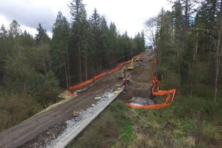 Excavation of existing roadway in preparation for new multi-span pre-stressed concrete girder bridge